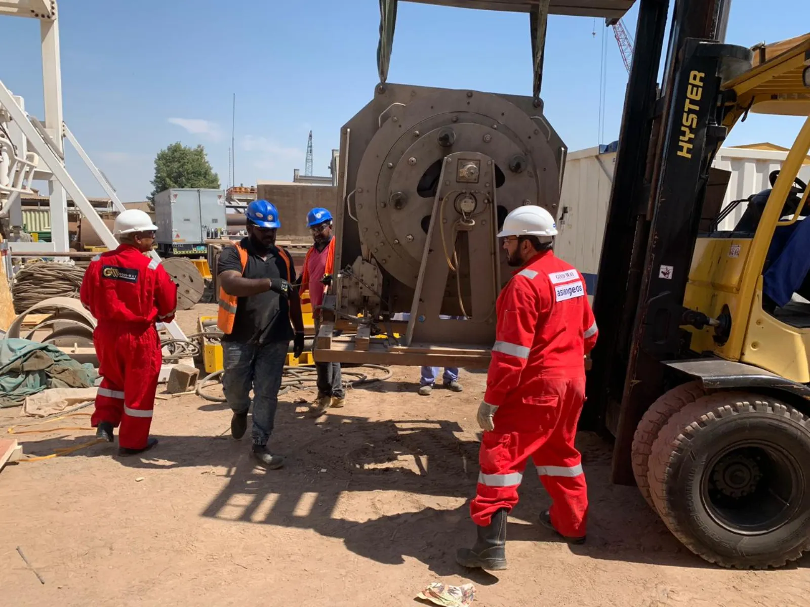 ASIANGEOS technicians handling survey equipment with forklift